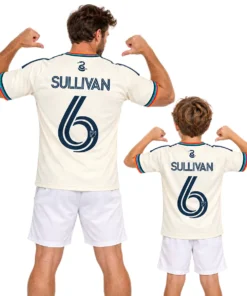 Father and son wearing matching cream Philadelphia Union Sullivan No. 6 jerseys with multicolor trim