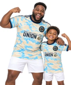 Father and son wearing matching Philadelphia Union cream-blue jerseys featuring Sullivan No. 6