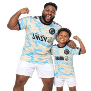 Father and son wearing matching Philadelphia Union cream-blue jerseys featuring Sullivan No. 6