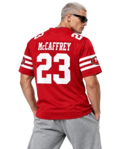 Male model wearing red Christian McCaffrey 49ers jersey with McCAFFREY name and white number 23 on the back