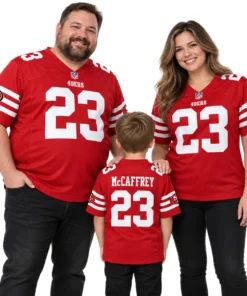 Father, mother and young son wearing matching red Christian McCaffrey 49ers number 23 football jerseys