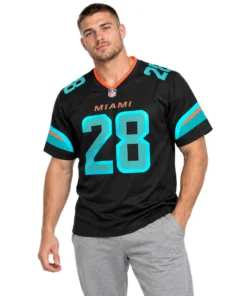 Model wearing an Achane #28 jersey in black with aqua and orange details