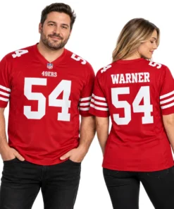 Man and woman modeling matching red Fred Warner 49ers jerseys, showing white number 54 on the front and WARNER lettering on the back