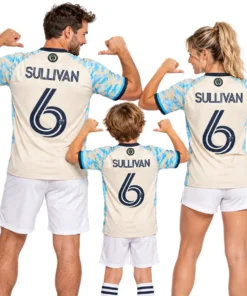Family wearing matching cream and sky-blue Philadelphia Union Sullivan No. 6 jerseys