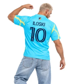 Model wearing cyan Milan Iloski Philadelphia Union away jersey with yellow lightning and navy graphics
