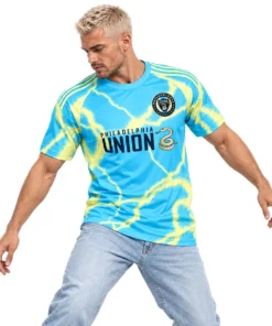 Model wearing cyan Milan Iloski Philadelphia Union away jersey with yellow lightning and navy graphics