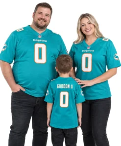 Family wearing matching Dolphins home football jersey styles in aqua