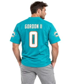 Model wearing a Gordon II #0 jersey in aqua with white and orange details