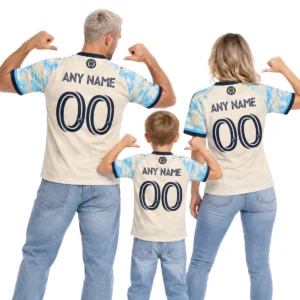 Father, mother and son wearing matching cream and sky-blue Philadelphia Union throwback soccer jerseys