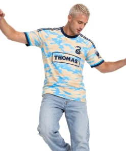 Model wearing cream and sky-blue Philadelphia Union retro soccer jersey with navy collar and chest graphics