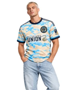 Model wearing Philadelphia Union cream away soccer jersey with sky-blue camo design and navy trim