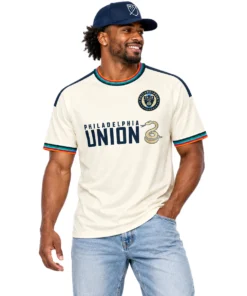 Model wearing cream Philadelphia Union third soccer jersey with navy graphics and colorful striped trim